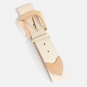 Detail of a wide elastic waist belt featuring a polished rose gold irregular metal buckle