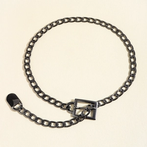 Detailed macro shot of gunmetal chunky chain belt with square buckle and oval charm