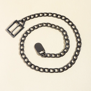 Detail of matte black punk style metal chain belt with a sleek rectangular buckle
