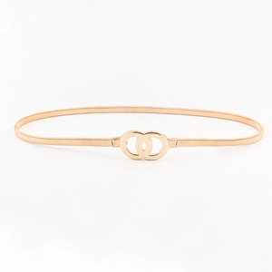 Detail of golden elastic metal waist belt with interlocking double O-ring buckle for women