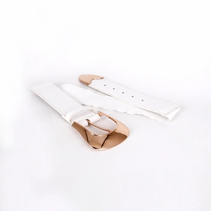 Detail of white elastic waist belt featuring rose gold curved buckle and textured fabric
