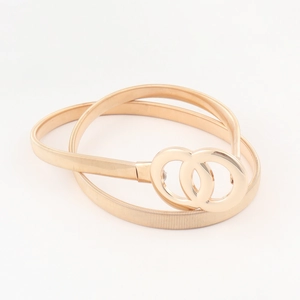 Detailed macro view of the stretchable golden spring belt with interlocking O-ring buckle