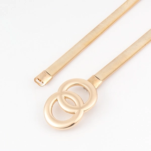 Close-up of golden elastic metal waist belt featuring double O-ring buckle for women