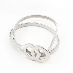Detail of silver metallic stretch spring belt for women with interlocking double ring buckle