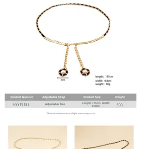 Detail of woven gold metal waist chain with black inlay and white pearl flower charm