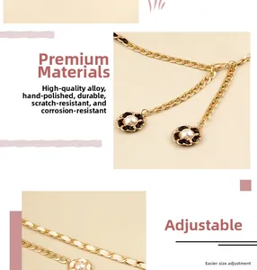 Detail of golden metal waist chain with camellia pearl pendant and adjustable links