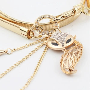 Detail of golden fox pendant with sparkling rhinestones on an elastic metal belt
