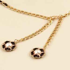 Elegant woven metal waist chain with pearls and floral pendants in gold finish