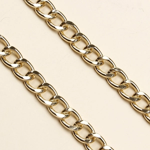 Macro view of gold metal link chain with flat oval interlocking structure for accessories