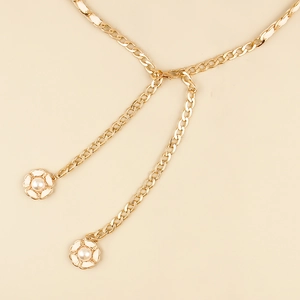 Close-up of golden metal waist chain with elegant white camellia flower and pearl charms