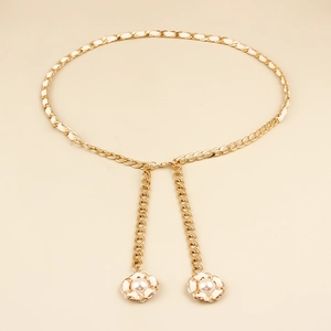 Detail of woven gold chain belt with white leather and camellia pearl pendant