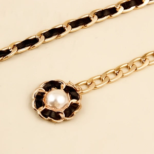 Elegant woven gold chain and black leather waist belt with pearl flower detail