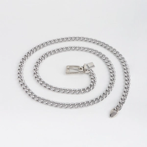 Close-up of silver Cuban chain belt with a heart-shaped pendant on a white background
