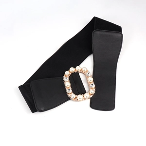 Close-up of elastic wide waist belt featuring gold oval buckle with pearls and rhinestones