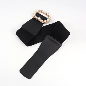 Detailed macro view of an elastic waist belt with rhinestones and faux pearls