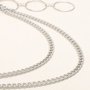 Silver punk style double layer pant chain with circular pendant on cream background