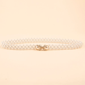 Elegant triple-row pearl waist belt with a golden rhinestone bow buckle for dresses