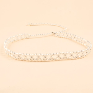 Detail of white woven pearl waist chain with rhinestone star charms and lobster clasp