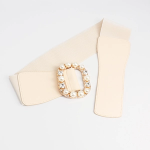 Close-up of elastic waist belt with luxury faux pearl and rhinestone gold metal buckle
