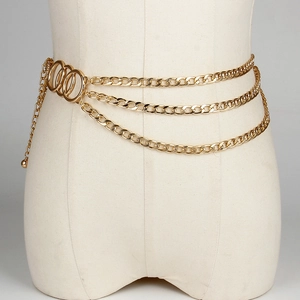 Detail of multilayered gold metal waist chain with elegant round ring accents on a mannequin