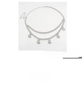 Detail of silver double-layered metal waist chain with intricate dragon pendants