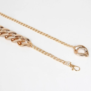 Macro view of polished gold chunky chain belt with lobster clasp and round rings
