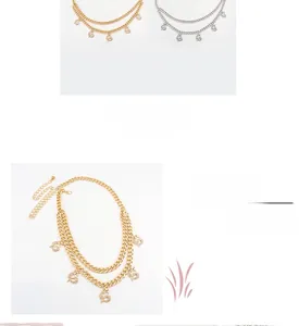 Detail showing gold double-layer chain with small dragon charms and faux diamond accents