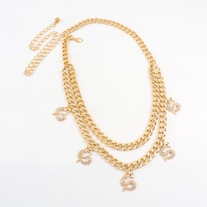 Close-up of golden double-layer chain waist belt featuring five dragon pendants with rhinestones