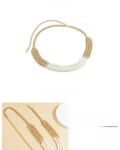 Detailed macro view of triple-layer gold chain with white pearl stitching and adjustable clasp