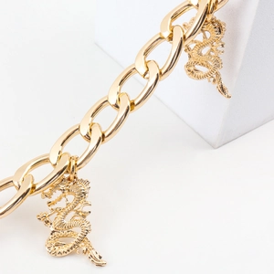 Detailed close-up of golden metal waist chain with two Chinese dragon-shaped charms