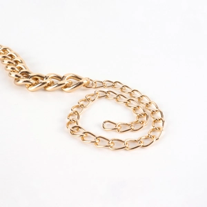 Close-up of golden multi-layered metal belt chain with polished Cuban link detail