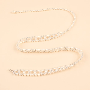 Detail view of woven white pearl waist chain with lobster clasp and hollow mesh structure