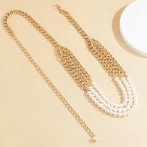 Detailed macro view of triple-layer pearl chain belt with gold links and lobster clasp