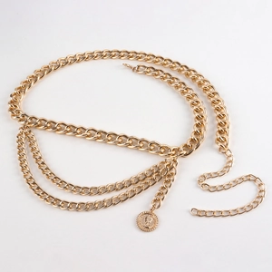 Detail view of gold triple-layer waist chain with coin pendant and lobster clasp
