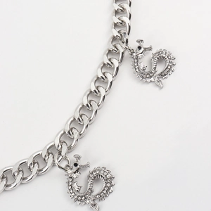 Close-up of double layer silver dragon pendant chain with sparkling rhinestones
