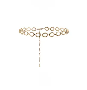 Detail of golden twist texture metal ring belt showing linked circular chain design