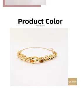 Detail of the chunky golden punk style metal chain link and lobster clasp closure