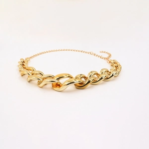 Detail shot of chunky gold hip hop body chain with thick links and lobster clasp