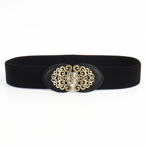 Detailed view of an antique bronze alloy buckle on a black vintage elastic waist belt