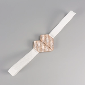 Détail d'une ceinture élastique blanche avec boucle cœur scintillante en strass et or rose