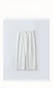 Detail view of the waistband and zipper fly on white straight-leg lyocell casual trousers
