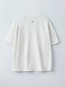 Minimalist white short-sleeve T-shirt back view with drop shoulder and small metal logo