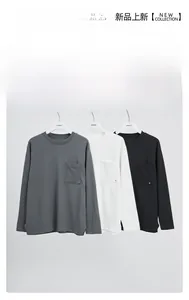 Detail of crew neck long sleeve t-shirts with chest pockets in gray white and black