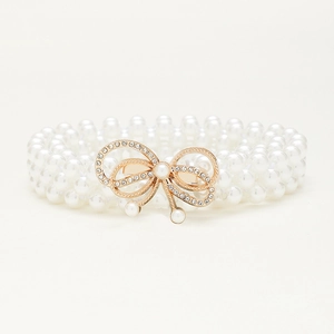Elegant triple-layer pearl elastic waist belt with a sparkling rhinestone bow buckle design