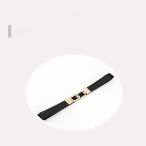 Close-up of elegant gold double ring buckle on a slim black waist belt for women