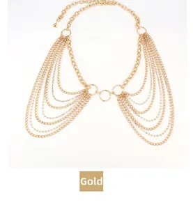 Detail of multi-layered golden metal body chain with cascading links and rhinestones