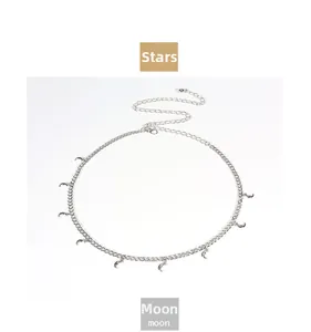 Detail view of silver metal body chain featuring multiple polished crescent moon pendants