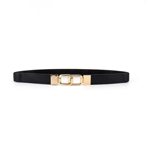 Detail of the golden interlocking buckle on a black elastic women's belt for dresses