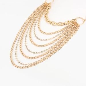 Detail of multilayered gold chain belt with sparkling rhinestones and metallic punk style