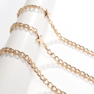 Detailed close-up of golden star charms and metal links on a body chain jewelry